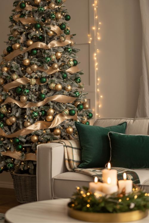 Elegant living room Christmas decor with green and gold color palette, velvet pillows, festive tree, and cozy holiday accents.