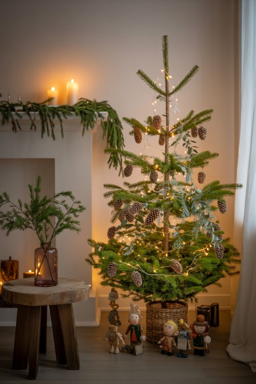Living room decorated for Christmas with pinecones, eucalyptus, fresh garlands, and a cozy festive tree.